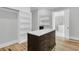 Spacious walk-in closet with hardwood floors, custom built-in shelves, and a dark island counter at 2777 Oak Manor Dr, Mount Pleasant, SC 29466