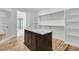 Bright walk-in closet with custom storage and a large center island for accessories and organization at 2777 Oak Manor Dr, Mount Pleasant, SC 29466