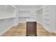 Custom walk-in closet with hardwood floors, a center island, and lots of shelf and hanging storage at 2777 Oak Manor Dr, Mount Pleasant, SC 29466