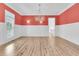 Bright dining room features a decorative chandelier, white wainscoting and wood flooring at 2777 Oak Manor Dr, Mount Pleasant, SC 29466