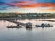 Scenic view of a long wooden dock leading to boats on calm waters at sunset at 2777 Oak Manor Dr, Mount Pleasant, SC 29466
