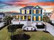 Charming two-story home with a inviting front porch and manicured lawn under a beautiful sunset at 2777 Oak Manor Dr, Mount Pleasant, SC 29466