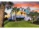 Stunning two-story home with lush landscaping and a colorful sunset background at 2777 Oak Manor Dr, Mount Pleasant, SC 29466