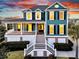 Charming teal two-story home featuring a welcoming front porch and manicured landscaping at 2777 Oak Manor Dr, Mount Pleasant, SC 29466