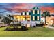 Beautiful teal home with a welcoming front porch and well-maintained lawn at dusk at 2777 Oak Manor Dr, Mount Pleasant, SC 29466