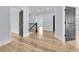 Hallway with wood flooring, neutral paint, and black paneled doors at 2777 Oak Manor Dr, Mount Pleasant, SC 29466