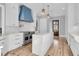 Open kitchen design features custom range hood, white cabinets and a kitchen island at 2777 Oak Manor Dr, Mount Pleasant, SC 29466