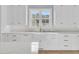 Bright kitchen features a white farmhouse sink, modern faucet and bright natural light at 2777 Oak Manor Dr, Mount Pleasant, SC 29466