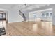 Open-concept living space with hardwood floors, white trim, and a staircase leading to upper level at 2777 Oak Manor Dr, Mount Pleasant, SC 29466