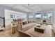 Staged living room featuring a tufted sofa, elegant decor, and open access to the kitchen and outdoor view at 2777 Oak Manor Dr, Mount Pleasant, SC 29466