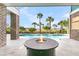 Beautiful outdoor area with a fire pit, pool, brick columns, and palm trees, ideal for relaxation at 2777 Oak Manor Dr, Mount Pleasant, SC 29466