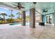 Inviting outdoor patio with brick columns, ceiling fans, and view of the pool and waterfront beyond at 2777 Oak Manor Dr, Mount Pleasant, SC 29466