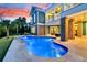 Inviting pool area with lush greenery, a firepit, and elegant brick detailing for upscale outdoor living at 2777 Oak Manor Dr, Mount Pleasant, SC 29466