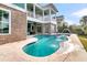 Inviting blue swimming pool with water features and an outdoor fire pit on the patio at 2777 Oak Manor Dr, Mount Pleasant, SC 29466