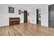 Open concept room featuring beautiful hardwood floors, a piano, and two doors to other areas of the house at 2777 Oak Manor Dr, Mount Pleasant, SC 29466