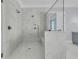 Bright, marble tiled walk-in shower featuring dual shower heads, a glass door, and a built in bench at 2777 Oak Manor Dr, Mount Pleasant, SC 29466