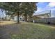 Fenced backyard with mature landscaping, a shed, and a covered back porch at 305 Meadowlark Ln, Moncks Corner, SC 29461