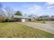 Spacious home featuring a long driveway, a covered area, and well-kept landscaping at 305 Meadowlark Ln, Moncks Corner, SC 29461