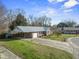 A charming one story house with a carport, a garage, and a well maintained lawn at 305 Meadowlark Ln, Moncks Corner, SC 29461