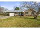 A charming one story house with a carport, a garage, and a well maintained front lawn at 305 Meadowlark Ln, Moncks Corner, SC 29461