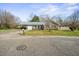 A charming one story house with a carport, a garage, and a well maintained front lawn at 305 Meadowlark Ln, Moncks Corner, SC 29461