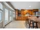 Bright kitchen area with wooden cabinets, granite countertops, and bar seating at 305 Meadowlark Ln, Moncks Corner, SC 29461