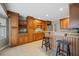 Well-designed kitchen area featuring wooden cabinets, granite counters, and stylish barstools at 305 Meadowlark Ln, Moncks Corner, SC 29461