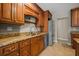 Well-lit kitchen boasts custom wood cabinets, granite countertops, and stainless steel appliances at 305 Meadowlark Ln, Moncks Corner, SC 29461