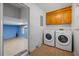 Bright laundry room features side-by-side washer and dryer and ample cabinet storage at 305 Meadowlark Ln, Moncks Corner, SC 29461