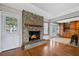 Cozy living room featuring a brick fireplace and seamless access to the kitchen at 305 Meadowlark Ln, Moncks Corner, SC 29461