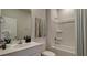 Bright bathroom with modern vanity, framed art and shower over a bathtub at 314 Tiliwa St, Summerville, SC 29486