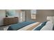 Comfortable bedroom with a large window, dresser and soothing decor and a view through the doorway at 314 Tiliwa St, Summerville, SC 29486