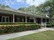 Elegant clubhouse featuring a brick facade, white pillars and meticulously landscaped grounds and sidewalks at 317 Commons Way, Goose Creek, SC 29445
