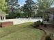 A refreshing community pool surrounded by lush landscaping and comfortable lounge chairs at 317 Commons Way, Goose Creek, SC 29445