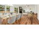 Dining room with large windows, hardwood floors, and open access to living room at 317 Commons Way, Goose Creek, SC 29445