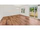Dining room with sliding glass doors, white trim, hardwood floors, and abundant lighting at 317 Commons Way, Goose Creek, SC 29445