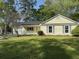 Charming single-story home boasts a manicured lawn, inviting porch and attached garage, perfect for suburban living at 317 Commons Way, Goose Creek, SC 29445
