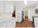 Bright kitchen featuring white cabinetry, countertops, stainless appliances, and hardwood floors at 317 Commons Way, Goose Creek, SC 29445