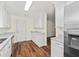 Bright kitchen featuring white cabinets, countertops, stainless appliances, and hardwood floors at 317 Commons Way, Goose Creek, SC 29445