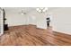 Open concept living room with hardwood floors, vaulted ceilings, and open access to the kitchen at 317 Commons Way, Goose Creek, SC 29445