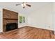 Spacious living room with brick fireplace, ample lighting, and hardwood floors at 317 Commons Way, Goose Creek, SC 29445