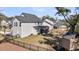 A backyard with black metal fence, screened-in porch and wood playhouse highlight this home at 3199 Great Egret Dr, Johns Island, SC 29455