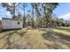 Large backyard featuring a storage shed, play structure, mature trees, and a partial fence at 3199 Great Egret Dr, Johns Island, SC 29455