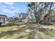 Expansive backyard featuring a storage shed, playground, mature trees, and a wooded backdrop at 3199 Great Egret Dr, Johns Island, SC 29455