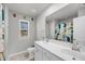 Bathroom with double sinks, large mirror, and a shower curtain with an animal print at 3199 Great Egret Dr, Johns Island, SC 29455