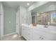 Bathroom featuring double sinks, large mirror, and a shower and tub at 3199 Great Egret Dr, Johns Island, SC 29455