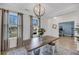 Dining room boasts natural light from large windows, complemented by modern light fixture and decor at 3199 Great Egret Dr, Johns Island, SC 29455