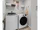 Bright laundry room with washer, dryer, overhead shelving, and laundry-themed wall art for added charm at 3199 Great Egret Dr, Johns Island, SC 29455