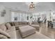 Open-concept living room with a large sectional, area rug, and access to the dining area at 3199 Great Egret Dr, Johns Island, SC 29455