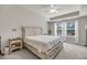 Bright main bedroom with a ceiling fan, bedside tables and large windows with sheer white curtains at 3199 Great Egret Dr, Johns Island, SC 29455